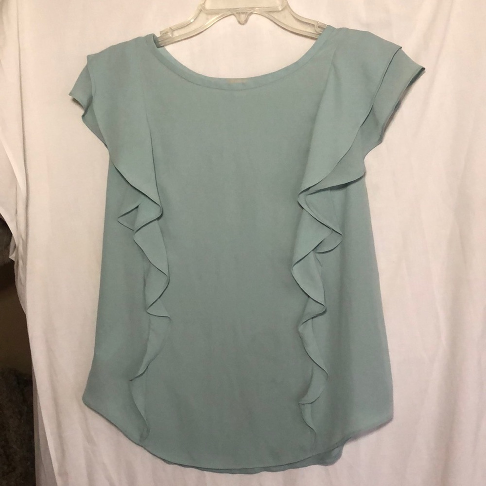 Light green sleeveless top with ruffles.